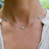 Woman with a Bayberry Grand & Classic 14k gold necklace featuring alternating 4 mm & 6 mm Nantucket blue topaz & turquoises