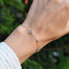 Hand with a Bayberry Grand & Classic cable chain bracelet in 14k gold featuring seven alternating 4 mm and 6 mm aquamarines
