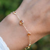 Hand with a Bayberry Grand & Classic cable chain bracelet in 14k gold featuring alternating 4 mm and 6 mm citrines