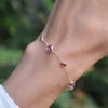 Hand with a Bayberry Grand & Classic cable chain bracelet in 14k gold with 4 mm & 6 mm pink tourmalines & pink sapphires