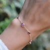 Woman with a Bayberry Grand & Classic cable chain bracelet in 14k gold with 4 mm & 6 mm pink tourmalines & pink sapphires