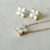 Pair of earrings and a Greenwich cable chain necklace featuring four 4 mm opals and one 2.1 mm diamond bezel set in 14k gold
