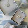A gift box with a Warren ring with accent diamonds featuring one 10 x 8 mm emerald cut white topaz bezel set in 14k gold 