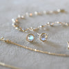Assorted jewelry including a Grand 14k gold cable chain necklace and stud earrings featuring 6 mm briolette cut moonstones