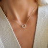 Woman wearing a Rosecliff Heart Necklace featuring twelve faceted round cut gemstones prong set in 14k yellow Gold