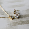 Two earrings and a Greenwich cable chain necklace featuring one 4 mm white topaz & one 2.1 mm diamond bezel set in 14k gold