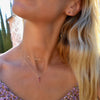 Woman wearing a Providence 3 Ruby vertical bar pendant and an Adelaide mini necklace in 14k yellow gold