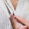 Woman's fingers holding several Birthstone Stud Earrings 