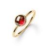 1.6 mm wide 14k yellow gold Grand ring featuring one 6 mm briolette cut bezel set garnet - angled view