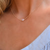 Woman with a Grand 14k yellow gold 1.17 mm cable chain necklace featuring one 6 mm briolette cut bezel set pink opal