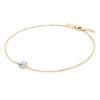 Grand 1.17 mm cable chain bracelet in 14k yellow gold featuring one 6 mm briolette cut bezel set aquamarine - angled view