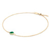 Grand 1.17 mm cable chain bracelet in 14k yellow gold featuring one 6 mm briolette cut bezel set emerald - angled view