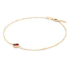 Grand 1.17 mm cable chain bracelet in 14k yellow gold featuring one 6 mm briolette cut bezel set garnet - angled view
