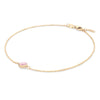 Grand 1.17 mm cable chain bracelet in 14k yellow gold featuring one 6 mm briolette cut bezel set pink opal - angled view