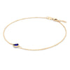 Grand 1.17 mm cable chain bracelet in 14k yellow gold featuring one 6 mm briolette cut bezel set sapphire - angled view