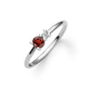 Greenwich ring featuring one 4 mm faceted round cut garnet and one 2.1 mm diamond prong set in 14k white gold