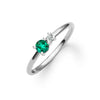 Greenwich ring featuring one 4 mm faceted round cut emerald and one 2.1 mm diamond prong set in 14k white gold