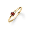 Greenwich ring featuring one 4 mm faceted round cut garnet and one 2.1 mm diamond prong set in 14k yellow gold - angled view