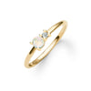 Greenwich ring featuring one 4 mm faceted round cut opal and one 2.1 mm diamond prong set in 14k yellow gold - angled view