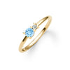 Greenwich ring featuring one 4 mm round cut Nantucket blue topaz and one 2.1 mm diamond prong set in 14k gold - angled view