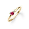 Greenwich ring featuring one 4 mm faceted round cut ruby and one 2.1 mm diamond prong set in 14k yellow gold - angled view