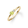 Greenwich ring featuring one 4 mm faceted round cut peridot and one 2.1 mm diamond prong set in 14k gold - angled view