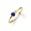 Greenwich ring featuring one 4 mm faceted round cut sapphire and one 2.1 mm diamond prong set in 14k gold - angled view