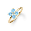 Greenwich ring featuring four 4 mm round cut Nantucket blue topaz and one 2.1 mm diamond prong set in 14k gold - angled view