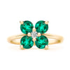 Greenwich ring featuring four 4 mm faceted round cut emeralds and one 2.1 mm diamond prong set in 14k gold - front view