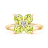 Greenwich ring featuring four 4 mm faceted round cut peridots and one 2.1 mm diamond prong set in 14k gold - front view