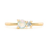 Greenwich ring featuring one 4 mm faceted round cut opal and one 2.1 mm diamond prong set in 14k yellow gold - front view