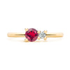 Greenwich ring featuring one 4 mm faceted round cut ruby and one 2.1 mm diamond prong set in 14k yellow gold - front view