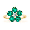 Greenwich ring featuring five 4 mm faceted round cut emeralds and one 2.1 mm diamond prong set in 14k gold - front view