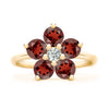 Greenwich ring featuring five 4 mm faceted round cut garnets and one 2.1 mm diamond prong set in 14k gold - front view