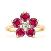 Greenwich ring featuring five 4 mm faceted round cut rubies and one 2.1 mm diamond prong set in 14k gold - front view