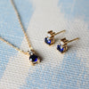 Pair of Greenwich earrings and a necklace in 14k gold featuring 4 mm faceted round cut sapphires and 2.1 mm diamonds