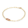 14k yellow gold Adelaide paperclip chain bracelet featuring one link encrusted with 1.5 mm pavé garnets - angled view