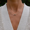 Woman with a 14k yellow gold Adelaide paperclip chain necklace featuring one link encrusted with 1.5 mm pavé alexandrites