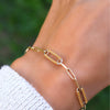 Woman wearing a 14k yellow gold Adelaide paperclip chain pavé bracelet featuring citrine-encrusted links