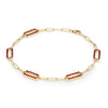 14k yellow gold Adelaide paperclip chain bracelet featuring five links encrusted with 1.5 mm pavé garnets - angled view