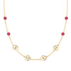 14k gold cable chain necklace featuring four rubies and four 1/4” flat engraved letter discs, spelling XOXO - front view