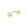 Pair of 14k yellow gold stud earrings each featuring one 1/4” flat disc engraved with the letter G - front view