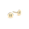 Pair of 14k yellow gold stud earrings each featuring one 1/4” flat disc engraved with the letter H - front view