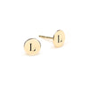Pair of 14k yellow gold stud earrings each featuring one 1/4” flat disc engraved with the letter L - front view