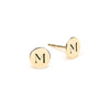 Pair of 14k yellow gold stud earrings each featuring one 1/4” flat disc engraved with the letter M - front view
