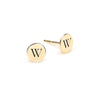 Pair of 14k yellow gold stud earrings each featuring one 1/4” flat disc engraved with the letter W - front view