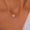 Woman with a 14k yellow gold cable chain necklace featuring one 1/4” flat disc engraved with the letter C