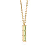 Providence Peridot vertical bar pendant featuring 3 petite baguette stones set in 14k yellow gold - angled view