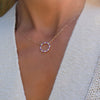 Woman wearing a Rosecliff open circle necklace with sixteen alternating 2 mm amethysts & diamonds prong set in 14k gold