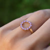 Hand wearing a Rosecliff small open circle ring featuring twelve 2 mm round cut amethysts prong set in 14k yellow gold